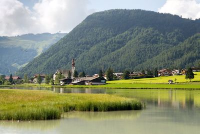 Scenic view of lake and mountains against sky