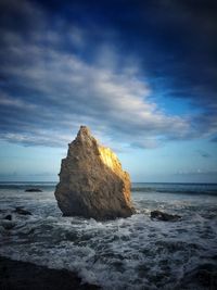 Scenic view of sea against cloudy sky