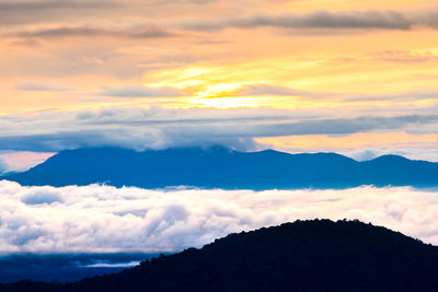 Scenic view of silhouette mountains against sky during sunset