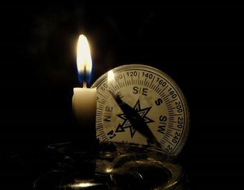 Close-up of electric lamp over black background