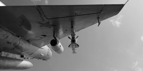 Low angle view of airplane flying against sky