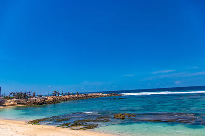 Scenic view of sea against blue sky