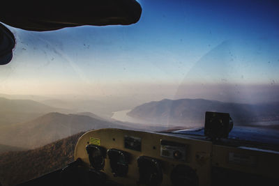 Scenic view of mountains against sky seen through car windshield