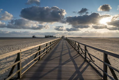 Panoramic view of empty beach against sky during sunset