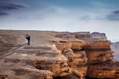 Rear view of man standing on hill