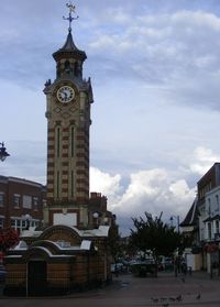 Clock tower against cloudy sky