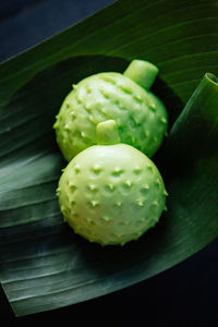 Close-up of green fruits on table