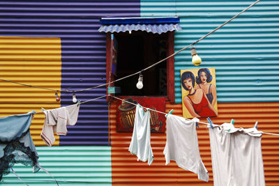 People holding multi colored umbrellas hanging on wall