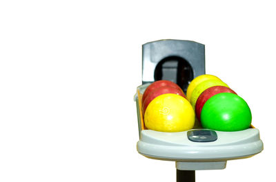 Close-up of toys on table against white background