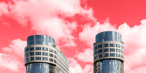 Low angle view of modern buildings against sky during sunset