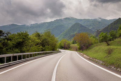 Road amidst mountains against sky