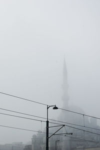 Dramatic sky over city during foggy weather