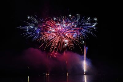 Low angle view of firework display at night