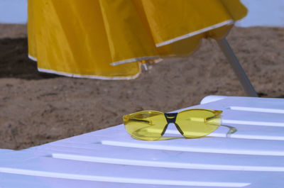 Close-up of yellow shoes on the beach