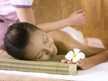 Close-up of woman giving massage to customer at spa
