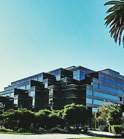 Low angle view of buildings against clear blue sky