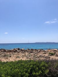 Scenic view of sea against blue sky