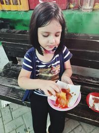 Cute girl holding ice cream in restaurant