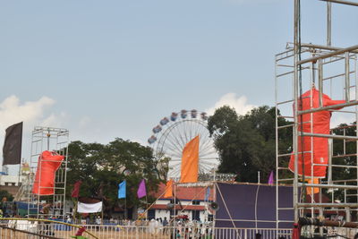 Ferris wheel in city against sky