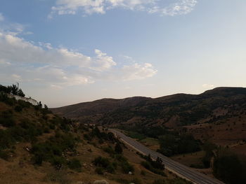 Countryside landscape against mountain range