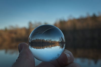 Close-up of hand holding crystal ball