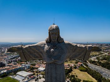 Statue of cityscape against clear sky