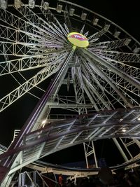 Low angle view of illuminated ferris wheel against sky at night