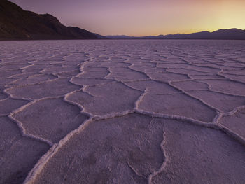 Scenic view of desert against sky during sunset