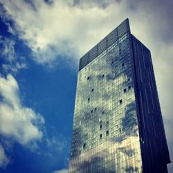 Low angle view of buildings against cloudy sky