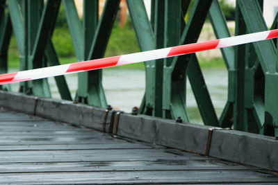 Close-up of red railing against plants