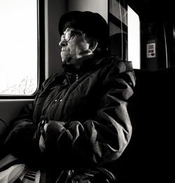 Man looking through window