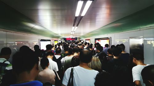 Crowd in illuminated corridor