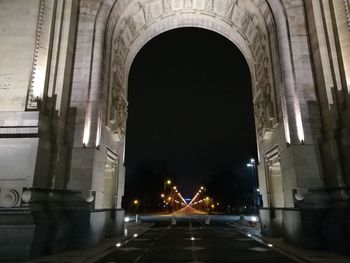 Illuminated road in city at night