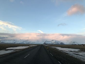 Surface level of road against sky during winter