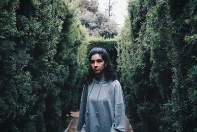 Portrait of happy woman standing in forest