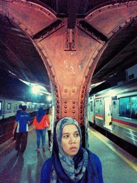 Portrait of woman standing on railing