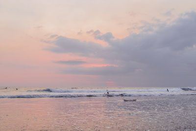 Scenic view of beach against sky during sunset