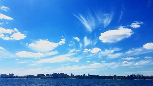 Scenic view of sea by city against sky