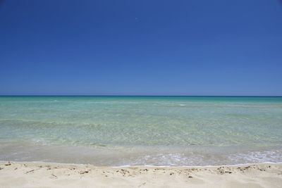 Scenic view of sea against clear blue sky