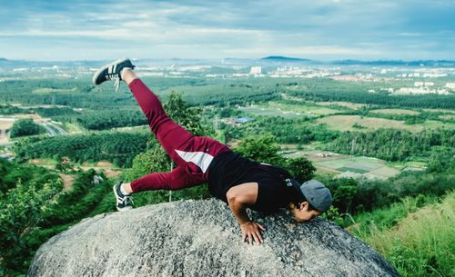 Man exercising on cliff