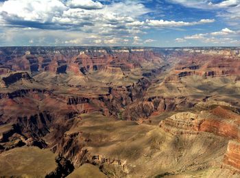 High angle view of rock formations against cloudy sky
