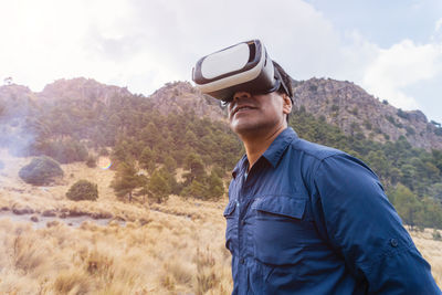 Man wearing virtual reality headset on field