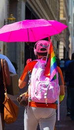 Man holding multi colored umbrella