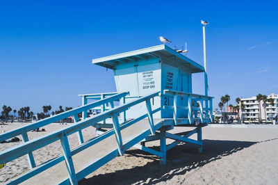 Built structure on beach against clear blue sky