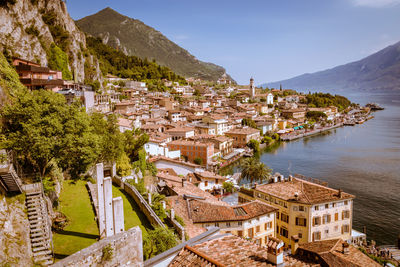 High angle view of townscape by mountain against sky