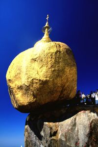 Low angle view of sculpture against rock