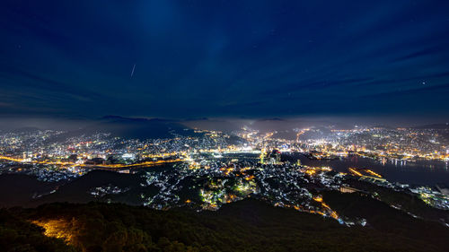 High angle view of illuminated buildings in city at night