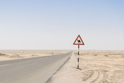 Sign warning of camels crossing in a rural road in the desert of the middle east 