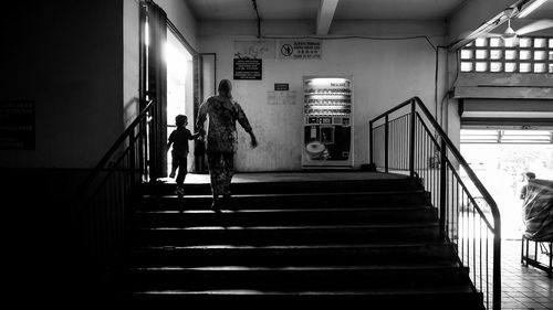 People walking on staircase in subway