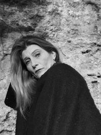 Portrait of woman standing against rock formation